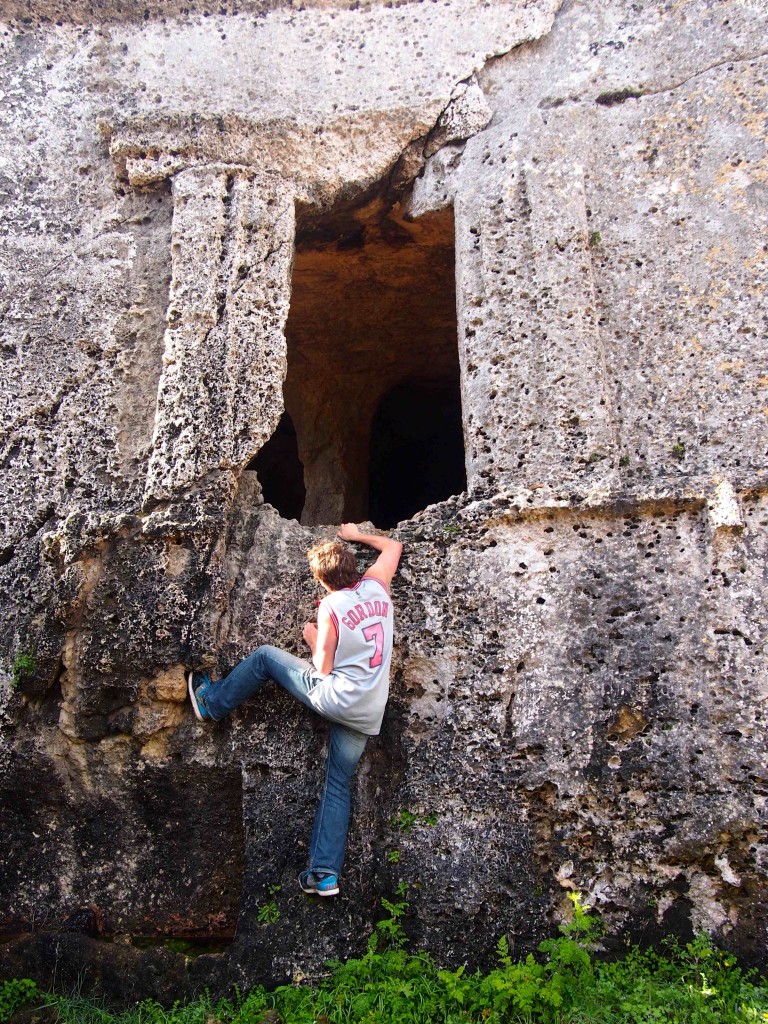 In true CC style, a student scales the ancient caves which were hand-carved to add ornamentation to burial chambers at the necropolis of Cala Morell