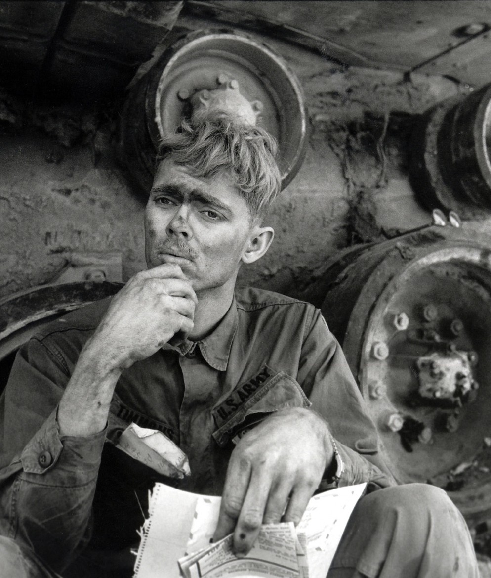 An American soldier reading a letter from home, Lang Vei, South Vietnam, 1971