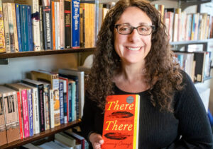Corinne Scheiner holding a copy of 'There There'