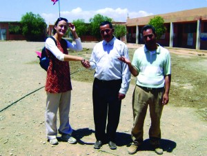 Pictured here, Lacey Ramirez ’05 in her Peace Corps village in the province of Ouarzazate, Morocco. The two men are teachers from the local elementary school and members of the town NGO. They developed a project to construct a water cistern at the elementary school so that the children would have access to potable water. The men managed the project, while Lacey helped them raise 75 percent of the funds.