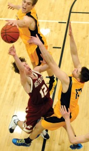 Jeremy Swisher, center, of Austin College didn’t have a chance as CC’s Chris Lesnansky ’15 swats away the ball and teammate Luke Winfield ’16 defends during their early January game. The Tigers defeated the Kangaroos 68-53 at Reid Arena.